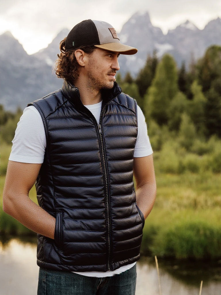 A sleek black leather puffer vest, perfect for layering in colder weather with its stylish and functional design.