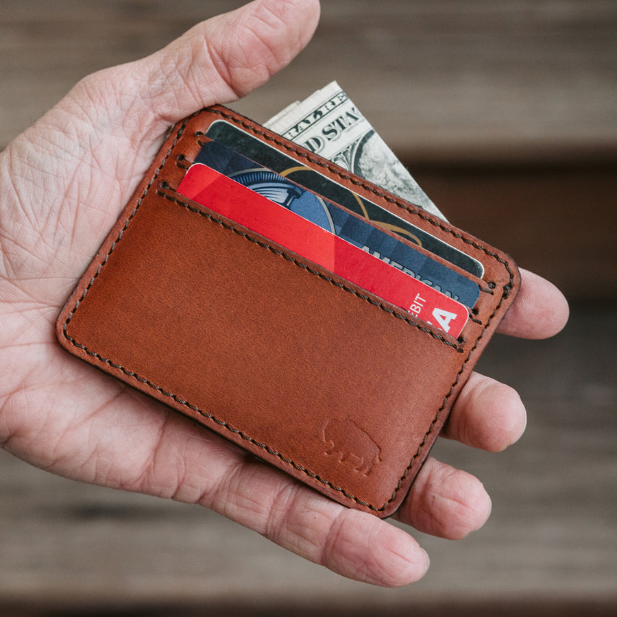 Amber brown Roosevelt slim ID leather wallet featuring a clear ID window and minimalist stitching.
