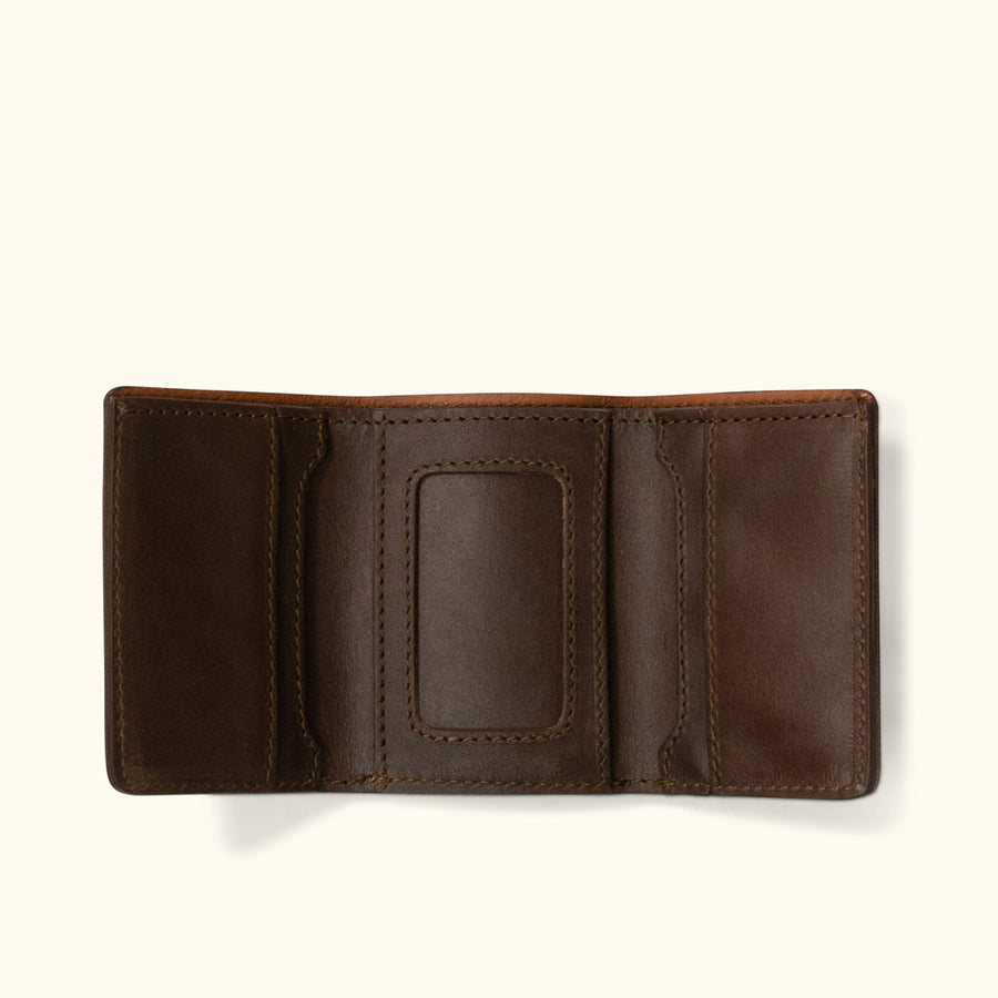 Brown leather trifold wallet, featuring a spacious interior with slots for cards and ID.