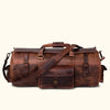Dark oak buffalo leather duffle bag with adjustable shoulder strap, top handles, and secure buckle closures for travel.
